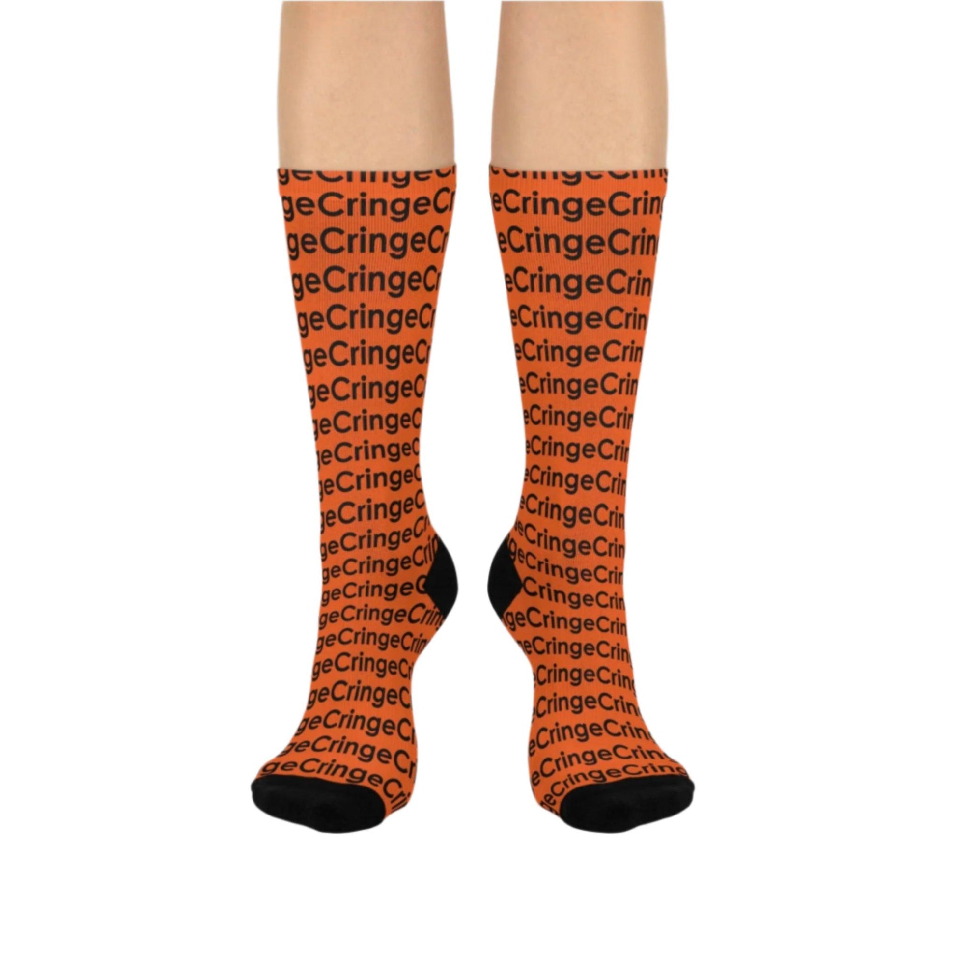 Bold crew socks featuring a repeating 'Cringe' text pattern in vibrant orange with black accents on the toe, heel, and cuff. Perfect for adding a playful edge to any outfit, from The Killer Tee.