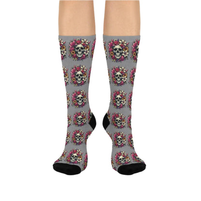 A pair of Lily Skull Crew Socks featuring a repeating pattern of skulls surrounded by lilies and roses .