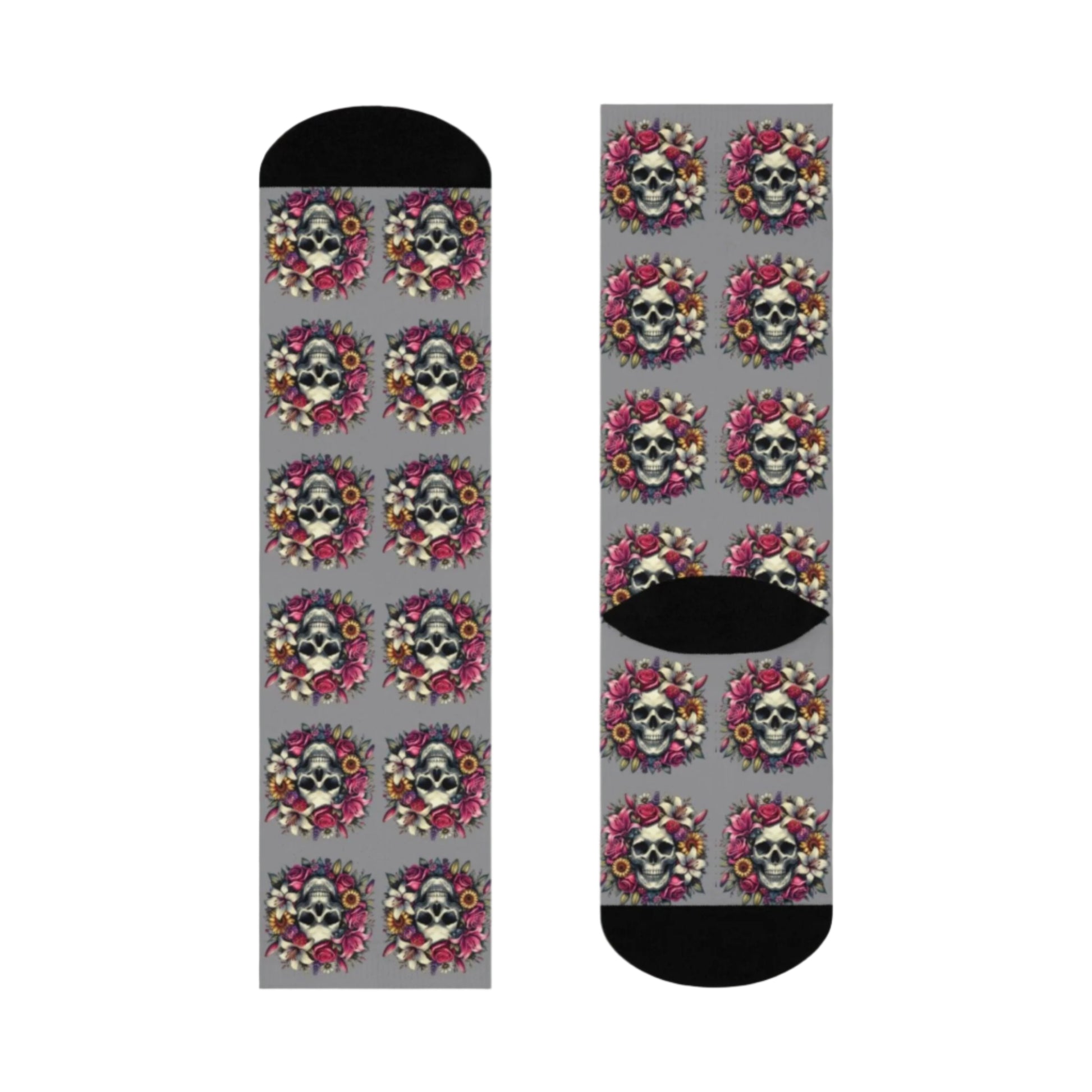 A pair of Lily Skull Crew Socks featuring a repeating pattern of skulls surrounded by lilies and roses on a gray background with black toe and heel accents. These socks blend edgy and floral designs, fitting women's size 5 US to men's size 12 US. From The Killer Tee.